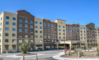 a large hotel building with multiple stories , located next to a parking lot and a shopping center at Soboba Casino Resort