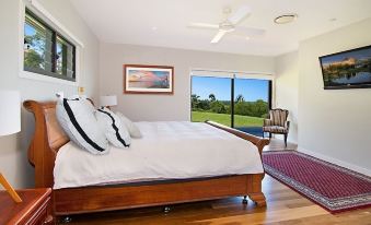 a bedroom with a large bed and sliding glass doors leading to an outdoor area at Ferncrest