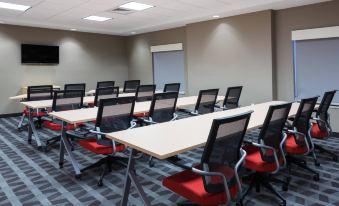 a conference room with several rows of chairs arranged in a semicircle around a long table at TownePlace Suites Gainesville Northwest