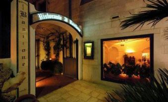 "an entrance to a building with a sign that reads "" ristorante "" and "" restaurant misano "". the building has a" at Covo dei Saraceni