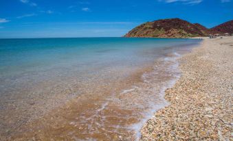 a serene beach scene with a group of people enjoying their time on the sandy shore at Comfort Inn & Suites Karratha