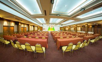 a large conference room with rows of tables and chairs arranged for a meeting or event at Phrae Nakara Hotel