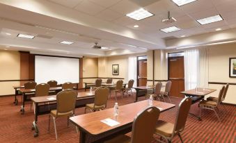 a large conference room with multiple rows of chairs arranged in a semicircle around a table at Hyatt Place Augusta