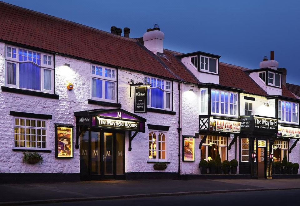 "a brick building with a sign that reads "" the lord 's house "" in front of it" at The Mayfield Seamer