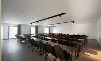 an empty conference room with multiple rows of chairs arranged in a semicircle , and a whiteboard on the wall at Octant Douro