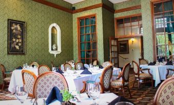 a dining room with tables and chairs set up for a formal meal , creating a elegant atmosphere at General Morgan Inn