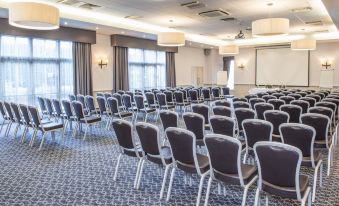 a large conference room with rows of chairs arranged in a semicircle , ready for an event at New Place