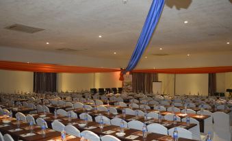a large conference room with rows of chairs and tables set up for a meeting at Tiffany Diamond Hotels - Mtwara