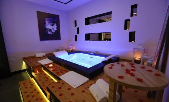 a luxurious bathroom with a large bathtub surrounded by rose petals , creating a romantic atmosphere at Hotel Delta