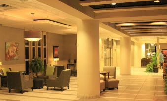a well - lit hotel lobby with multiple chairs and couches , creating a comfortable seating area for guests at Holiday Inn Portsmouth Downtown