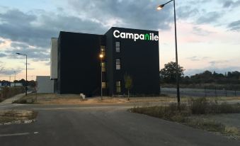 "a large black building with the word "" campa "" written on it , located in a city" at Campanile Laval Nord