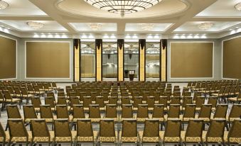 a large conference room with rows of chairs arranged in a semicircle , ready for an event at Sheraton Valley Forge King of Prussia