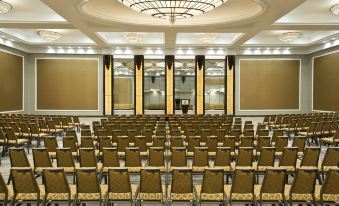 a large conference room with rows of chairs arranged in a semicircle , ready for a meeting or presentation at Sheraton Valley Forge King of Prussia