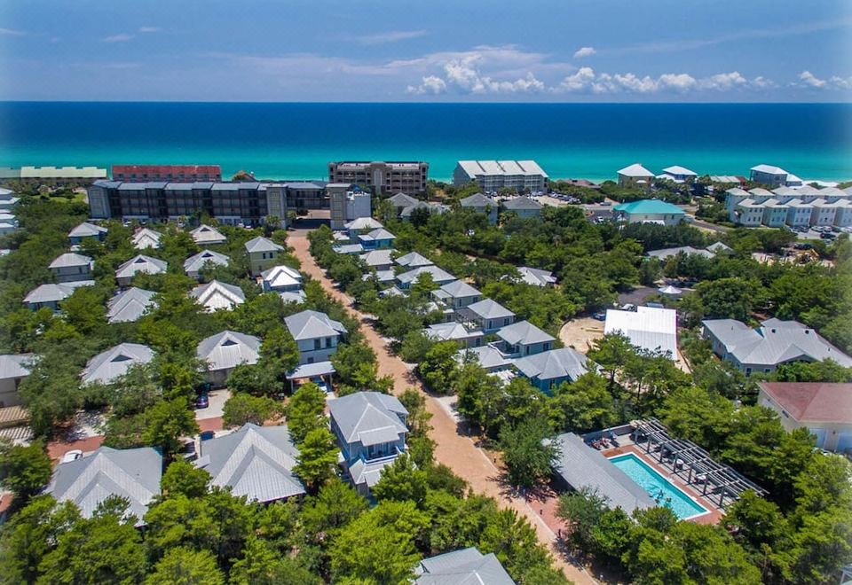 aerial view of a residential area near the ocean , with multiple houses and a swimming pool visible at Magnolia Cottages by the Sea by Panhandle Getaways