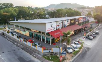 aerial view of a shopping mall with multiple buildings and cars parked in front of it at Hamilton Hotel Kajang