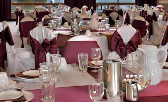 a large banquet hall filled with tables and chairs , ready for a formal event or a wedding reception at Red Lion Hotel Port Angeles Harbor