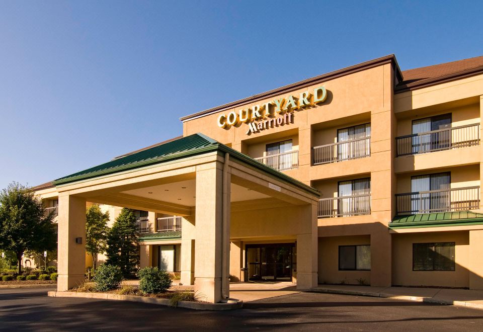 a courtyard by marriott hotel with a large sign above the entrance and a clear blue sky in the background at Courtyard by Marriott Scranton Montage Mountain