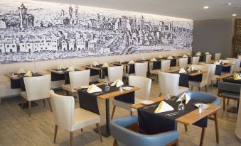 a dining room with tables and chairs arranged for a group of people to enjoy a meal together at AP Maria Nova Lounge