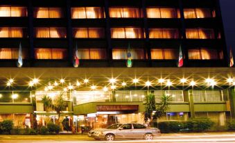 a hotel at night , with a car parked in front of it and lights from the outside at Hotel Frontera Clásico