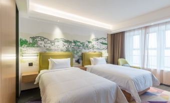 The standard twin room features double beds and a large window with a view of the pool area at Hampton by Hilton Ji'an