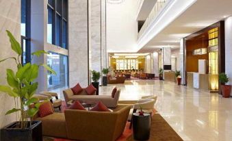 The second-floor lobby features an open concept design with couches and chairs at Four Points by Sheraton Kuching