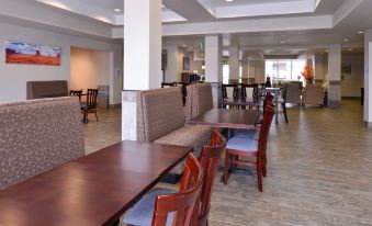 a dining area with several tables and chairs , some of which are made of wood at Holiday Inn Express & Suites Williams