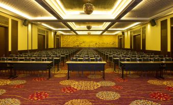 a large conference room with rows of tables and chairs , a yellow ceiling , and a red carpet at Salinda Resort Phu Quoc - Sparkling Wine Breakfast