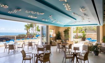 a large dining room with tables and chairs arranged for a group of people to enjoy a meal at Condado Vanderbilt Hotel