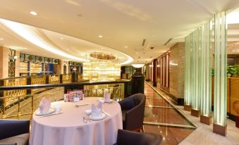 There is a dining room with a large table and chairs in the middle, as well as an adjacent area at Central Hotel Shanghai