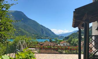 a beautiful view of a lake surrounded by mountains , with a house in the foreground at Gemma