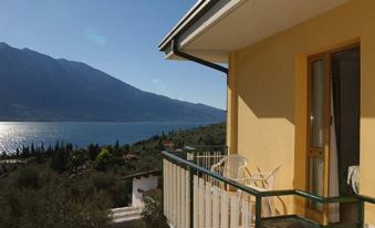 a yellow house with a balcony overlooking a body of water , possibly a lake or the ocean at Florida