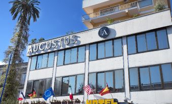 "a large hotel building with a sign that reads "" augustus hotel "" prominently displayed on the front" at Augustus
