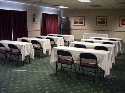a conference room set up for a meeting , with tables and chairs arranged in rows at Country Inn & Suites by Radisson, Watertown, SD