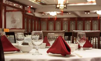a dining room with a table set for a meal , featuring a variety of dishes and utensils at Red Lion Inn and Suites Victoria