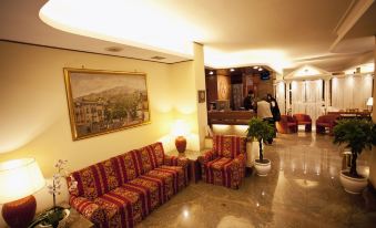 a hotel lobby with multiple couches and chairs arranged for guests to sit and relax at Augustus