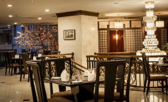 a well - decorated dining room with several tables and chairs arranged for guests to enjoy a meal at Super Hotel Candle