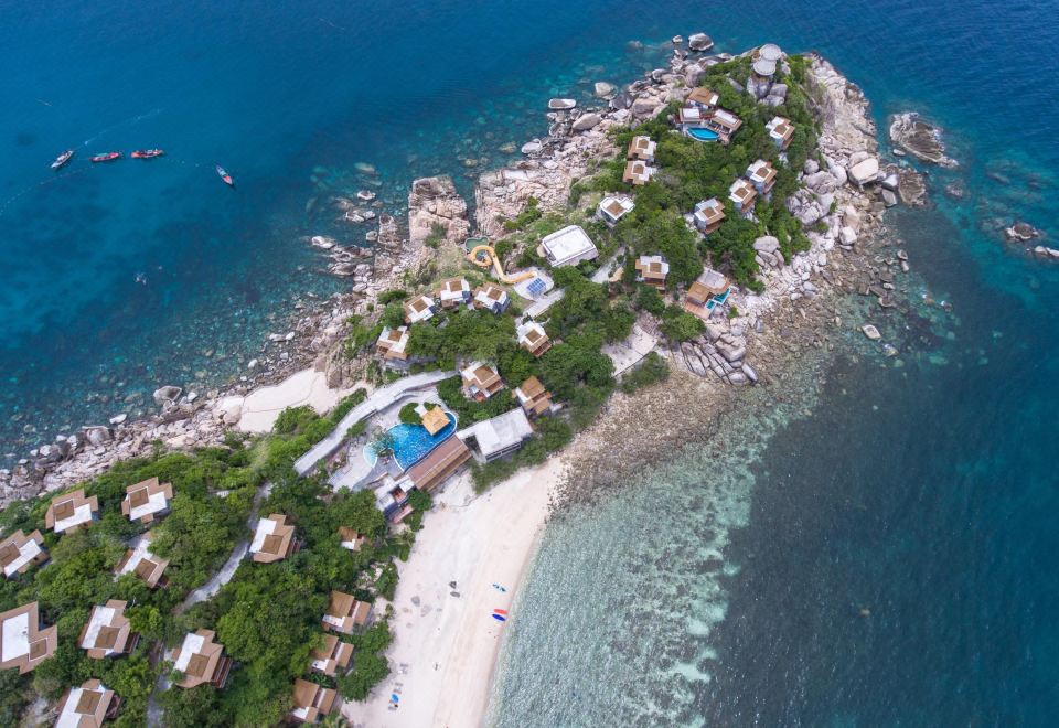 a bird 's eye view of a tropical island with white sandy beach , blue water , and lush greenery at Sai Daeng Resort