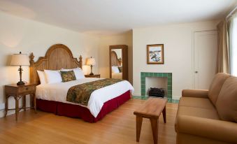 a hotel room with a king - sized bed , a fireplace , and a flat - screen tv . the room is well - appointed and well at Hawaii Volcano House