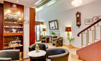 a well - decorated living room with various seating options , including couches , chairs , and a coffee table at Hotel National