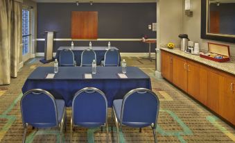 a conference room set up for a meeting , with several chairs arranged in rows and a table in the middle at Residence Inn Waldorf