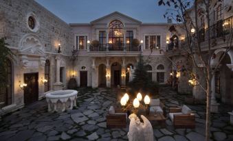 a large , elegant home with a courtyard and stone walkway , lit by candles and surrounded by outdoor furniture at Sacred House