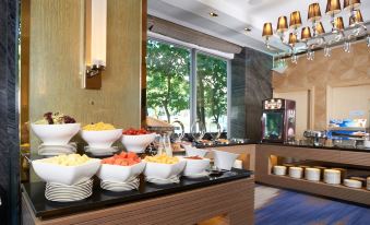 The restaurant has large windows and filled tables for guests to enjoy their meals at Dorsett Tsuen Wan