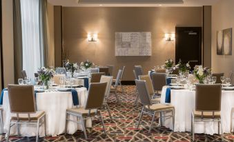 a large dining room with tables and chairs set up for a formal event , possibly a wedding reception at Residence Inn by Marriott Boston Needham