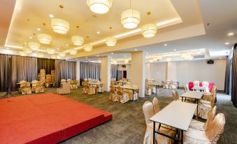 a large , empty banquet hall with tables and chairs set up for an event , under high ceiling lights at Livingston Hotel