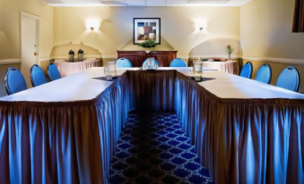 a conference room with blue carpeting , multiple tables and chairs arranged for a meeting or event at Best Western Cowichan Valley Inn