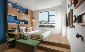 a spacious bedroom on the second floor with two beds and large windows at Campanile Hotel (Shanghai Jing'an Temple)