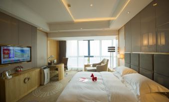a spacious bedroom with large windows and a double bed in the center at KinDream Hotel