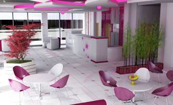 a modern office interior with pink and white accents , including a reception area and dining tables at favehotel Rembang