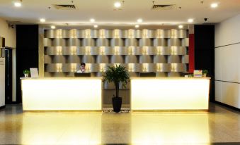 In the lobby, there is a reception desk with lights on both sides and an illuminated wall behind it at Hotel Sentral Seaview @ ​Beachfront