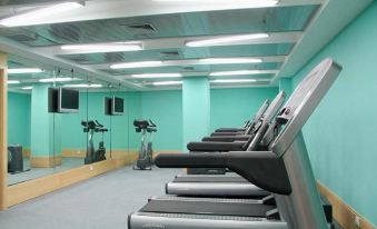 A spacious room in the center is equipped with treadmills and exercise equipment for everyone's use at Jinglun Hotel